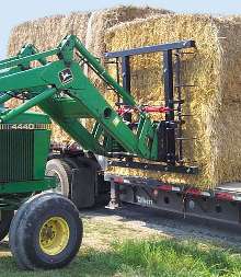Bale Handler stacks large rectangular bales.