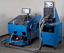 Machine drives fasteners into steel and aluminum sheets.