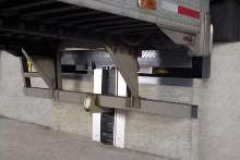 Recessed Vehicle Restraint secures trailers at dock.