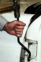 Tool removes door hinge bushings.