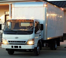 Delivery Truck has low cab-over-engine design.