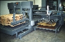 Pallet Pad Placer puts corrugated sheet down.