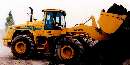 Wheel Loader has cab mounted on rear frame.
