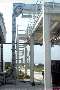 Continuous Sandwich Belt conveys bulk material vertically.