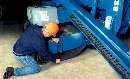 Absorbent Mat hangs under industrial vehicles.