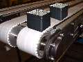 Conveyors help secure and separate items for assembly.