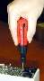 Screwdriver features retracting, self-storing bits.
