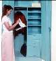Cabinet combines drawer, shelf, and wardrobe storage.