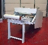 Flattener/Conditioner handles bags prior to palletizing.