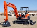 Compact Excavator has floating hydraulic angle blade.