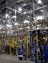 Curtain Enclosures protect robotic welding cells.