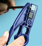 Combination Tool strips coax and UTP cable.