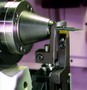 CNC Grinder grinds small cutting tools.