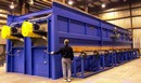 Gas-Fired Conveyor Oven preheats tubes for oil industry.