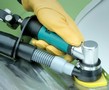 Air-Powered Finishing Sander captures dust, contaminants.