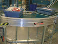 Belt Conveyor moves loads through curves to next conveyor.