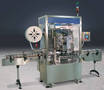 Packaging Machine applies tamper-evident shrinkbands to tubs.