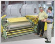 Vertical Roll Coater features space conserving design.