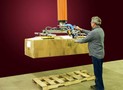 Vacuum Tube Lifter loads heavy cartons onto skids.