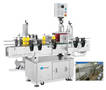 Labeling System applies front/back labels to round bottles.