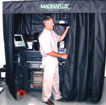 Enclosure facilitates magnetic particle inspections.