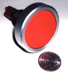 Adapter encases pushbutton switch.