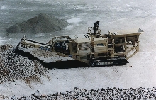 Track-Mounted Crusher goes to job site to crush stone.