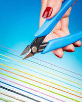 Ergonomic Scissor cleanly cuts difficult threads, cords, yarns.