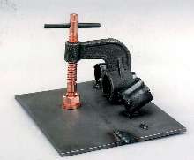 Clamp aligns material for welding applications.