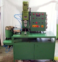 Riveting Machine features vibratory bowl feeder.