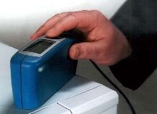 Meter measures coating gloss and thickness.