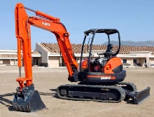 Compact Excavator has floating hydraulic angle blade.