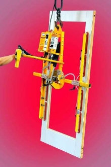 Vacuum Lifter unloads and reorients doors.