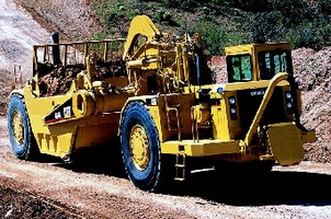 Tractor-Scraper comes equipped with bowl or auger.