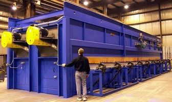 Gas-Fired Conveyor Oven preheats tubes for oil industry.