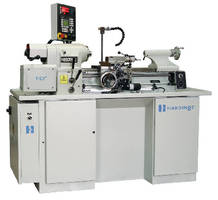 Lathe features electronic servo motor and threading computer.