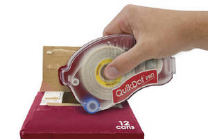 Adhesive Applicator seals corrugated packaging.