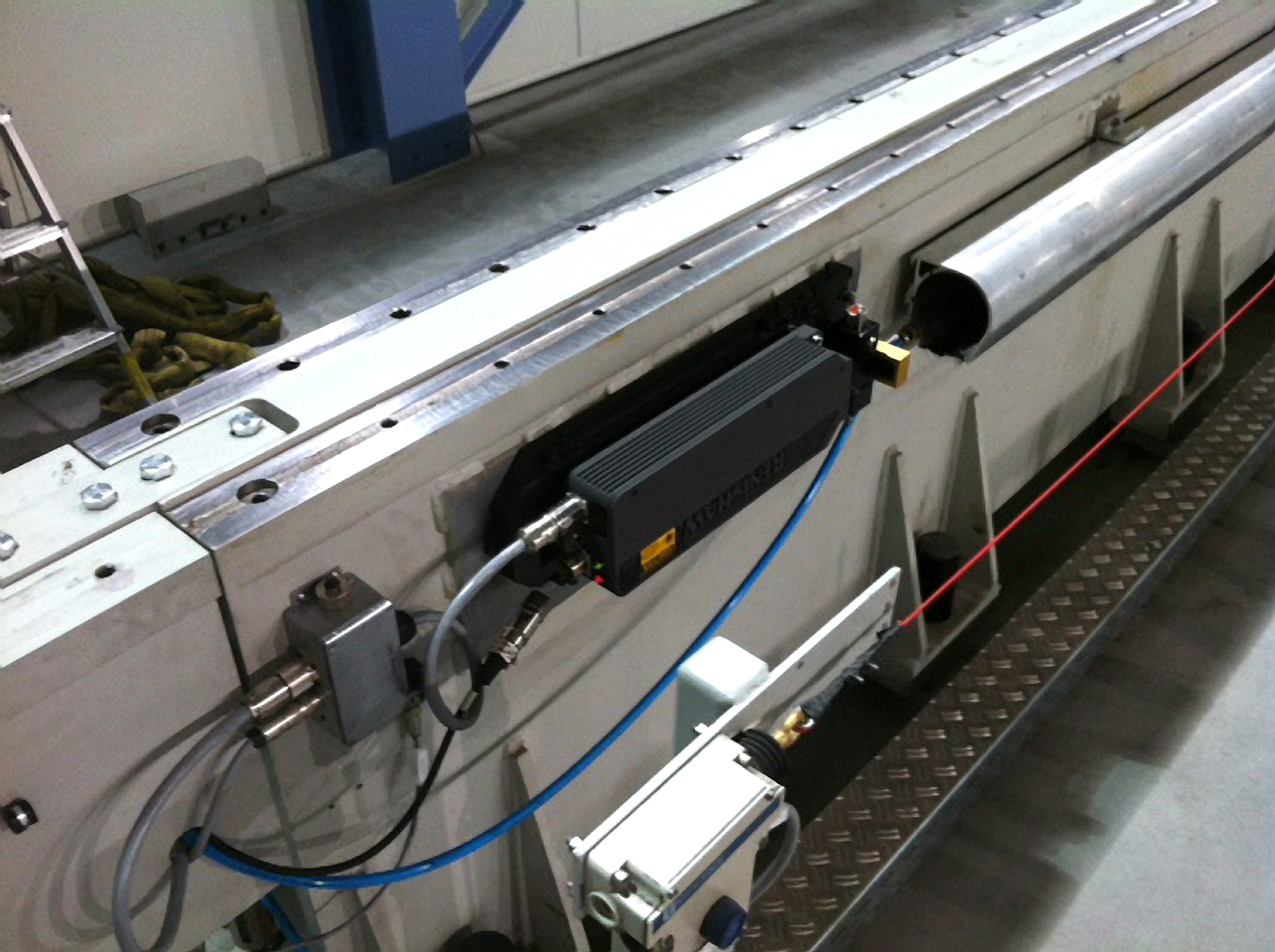 Two Renishaw laser encoders are mounted on both sides of the CMC. Their beams are directed down a special duct that is purged with clean air to preserve beam integrity. Credit: Flow International
