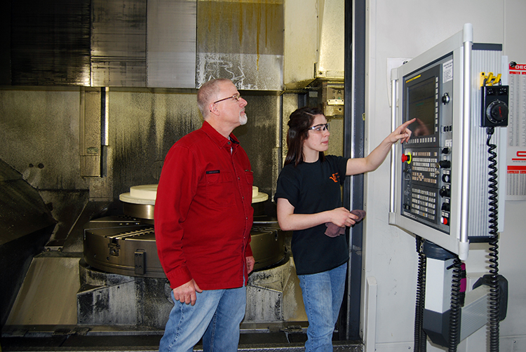 Pinch and Mid-Point Machine CEO John Halbach review a cutting program.